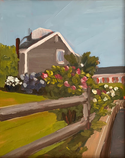 A painting titled 'After the Rain' featuring a gray house with a visible chimney, surrounded by a lush garden with various flowers and a wooden fence in the foreground.