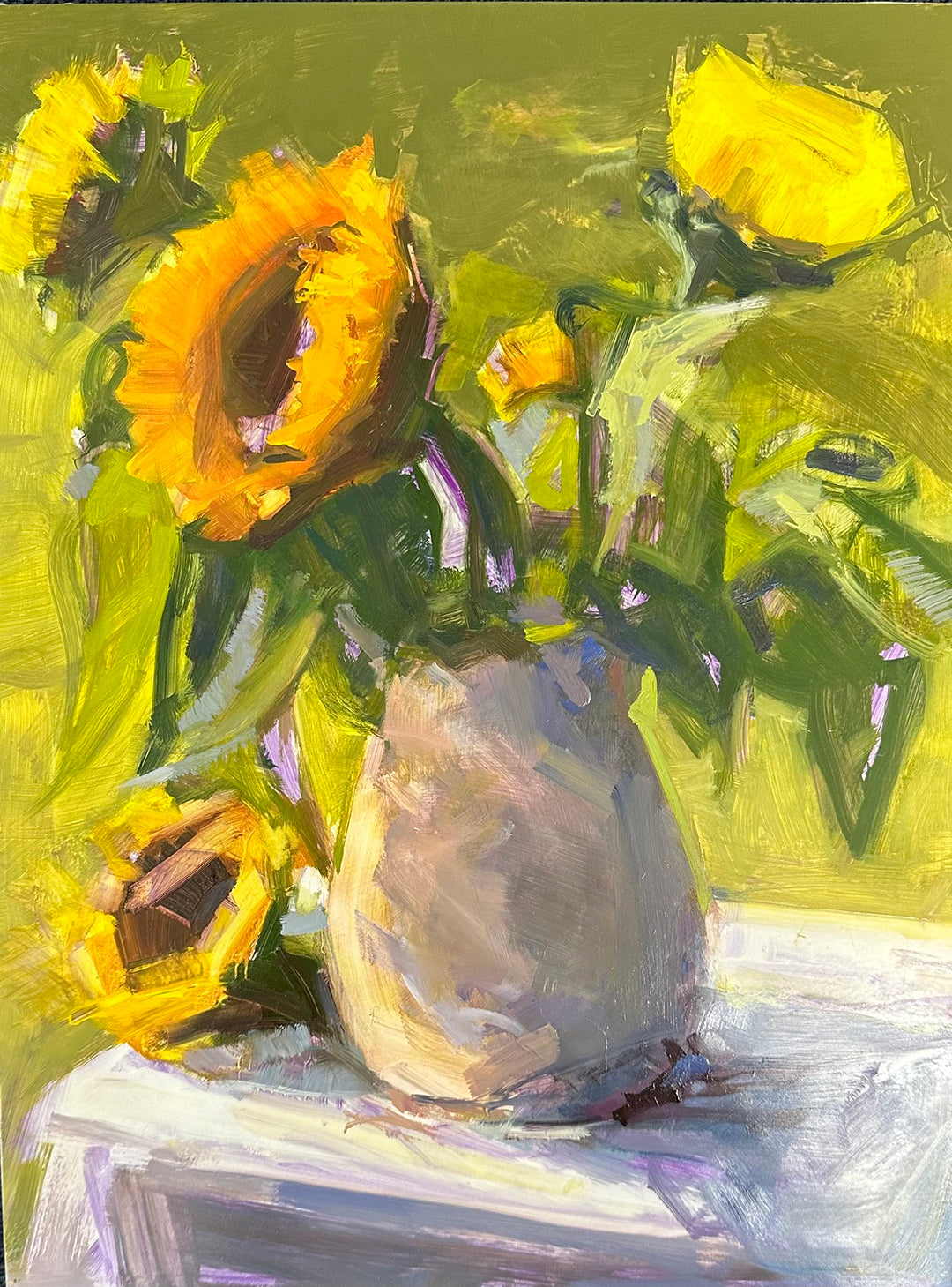 "Clare's Sunflower," a 12x16 inch oil painting on panel, vividly depicts a bouquet of sunflowers arranged in a beige vase. The painting is characterized by thick, expressive brush strokes in vibrant shades of yellow and green, capturing the dynamic texture and natural beauty of the sunflowers against a harmonious green background.